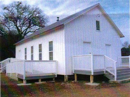 The Nameless Schoolhouse, a white one-room building