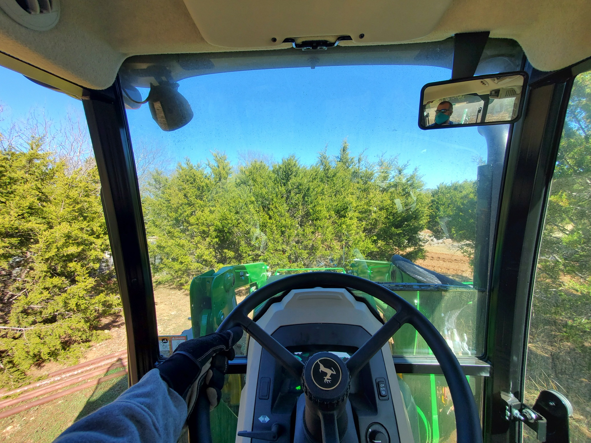 View from inside the tractor cab during grounds work